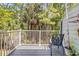 Relaxing deck featuring white railings and a chair overlooking a lush, verdant landscape at 2007 Royal Bay Blvd # 144, Kissimmee, FL 34746