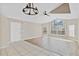 Bright and airy living room featuring large windows, ceiling fan, and modern light fixtures at 2007 Royal Bay Blvd # 144, Kissimmee, FL 34746