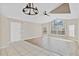 Bright living room with large windows and vaulted ceilings, featuring tile and wood floors at 2007 Royal Bay Blvd # 144, Kissimmee, FL 34746