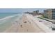 Expansive Daytona Beach view with white sands, blue ocean, and nearby condos under a sunny sky at 2401 S Atlantic Ave # D306, New Smyrna Beach, FL 32169
