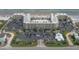 Wide aerial view of a condo building featuring a large parking lot and nearby beach access at 2401 S Atlantic Ave # D306, New Smyrna Beach, FL 32169