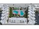 Aerial view of condo with beachfront pool, landscaping, shuffleboard, and building architecture at 2401 S Atlantic Ave # D306, New Smyrna Beach, FL 32169