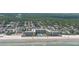 Aerial of condo and beach featuring palm trees, oceanfront location, and nearby residential neighborhood at 2401 S Atlantic Ave # D306, New Smyrna Beach, FL 32169