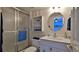 Bathroom featuring a glass-enclosed shower and a vanity with seashell-themed drawer pulls at 2401 S Atlantic Ave # D306, New Smyrna Beach, FL 32169