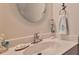 Neat bathroom features a decorative mirror, and a charming mermaid statue adding a whimsical touch at 2401 S Atlantic Ave # D306, New Smyrna Beach, FL 32169