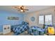 Bedroom with two twin beds, decorative wall art, and a ceiling fan at 2401 S Atlantic Ave # D306, New Smyrna Beach, FL 32169