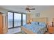 Bedroom with a coastal theme, private balcony and ceiling fan at 2401 S Atlantic Ave # D306, New Smyrna Beach, FL 32169