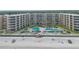 Oceanfront condo complex featuring palm trees, pools, and private beach access for residents at 2401 S Atlantic Ave # D306, New Smyrna Beach, FL 32169