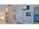 Hallway leading to a bathroom and bedroom with coastal-themed decor and access to an upper level at 2401 S Atlantic Ave # D306, New Smyrna Beach, FL 32169