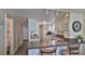 Kitchen featuring white cabinets, granite countertops, breakfast bar seating, and direct access to the hallway at 2401 S Atlantic Ave # D306, New Smyrna Beach, FL 32169
