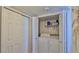 Convenient laundry area with washer, dryer, and shelving for storage, providing ease for laundry tasks at 2401 S Atlantic Ave # D306, New Smyrna Beach, FL 32169