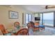Cozy dining/living space with a glass-top table, blue accents, and expansive ocean views at 2401 S Atlantic Ave # D306, New Smyrna Beach, FL 32169
