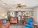 Comfortable living room with ceiling fan opens to kitchen with bar seating creating an inviting space for entertaining at 2401 S Atlantic Ave # D306, New Smyrna Beach, FL 32169