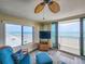 Oceanfront living room with updated furniture and stunning views of the beach from expansive windows at 2401 S Atlantic Ave # D306, New Smyrna Beach, FL 32169