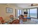 Cozy dining/living space with a glass-top table, blue accents, and expansive ocean views at 2401 S Atlantic Ave # D306, New Smyrna Beach, FL 32169