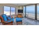 Oceanfront living room with updated furniture and stunning views of the beach from expansive windows at 2401 S Atlantic Ave # D306, New Smyrna Beach, FL 32169
