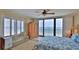 Serene main bedroom with large windows providing ocean views, a spacious layout and comfortable furnishings at 2401 S Atlantic Ave # D306, New Smyrna Beach, FL 32169