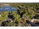 Aerial view showcasing a wooded property with lake access at 278 Silverstone Dr, Orange City, FL 32763