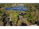 Lakefront home surrounded by mature trees with easy access to a community lake at 278 Silverstone Dr, Orange City, FL 32763