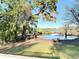 Scenic lake view from the backyard, featuring a private boat dock and mature trees providing a tranquil environment at 278 Silverstone Dr, Orange City, FL 32763