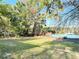 Backyard leading to a lakefront area with a small boat and a grassy lawn at 278 Silverstone Dr, Orange City, FL 32763