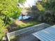 Secluded backyard with direct lake access, offering a private dock with a boat and captivating scenic views at 278 Silverstone Dr, Orange City, FL 32763