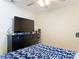 Bedroom featuring a dark dresser with a television and a patterned blanket at 278 Silverstone Dr, Orange City, FL 32763