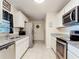 Efficient kitchen featuring stainless steel appliances, granite countertops, and bright white cabinets at 278 Silverstone Dr, Orange City, FL 32763