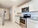 Well-appointed kitchen with stainless steel appliances, granite countertops, and tiled floors at 278 Silverstone Dr, Orange City, FL 32763