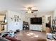 Spacious living area with luxury vinyl flooring, ceiling fan, and seamless connection to the dining area and backyard at 278 Silverstone Dr, Orange City, FL 32763