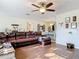 Inviting living room boasts a leather sectional, wood floors, and ceiling fan for comfortable living at 278 Silverstone Dr, Orange City, FL 32763