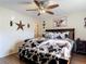 Warm and cozy main bedroom featuring a ceiling fan and a unique comforter set and throw pillows at 278 Silverstone Dr, Orange City, FL 32763