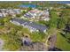 Aerial view of townhomes nestled among trees in a well-planned community near a lake at 2827 Upper Park Road, Orlando, FL 32814