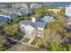 An aerial view of the community clubhouse with pool, surrounded by lush landscaping and a lake backdrop at 2827 Upper Park Road, Orlando, FL 32814