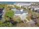 Aerial view of a community clubhouse and pool nestled among trees and buildings, near a lake at 2827 Upper Park Road, Orlando, FL 32814