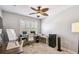 Home office featuring a ceiling fan, natural light, multiple desks, and a neutral color palette at 2827 Upper Park Road, Orlando, FL 32814