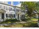 Charming two-story townhome showcasing classic architectural details, black shutters, and a well-manicured lawn at 2827 Upper Park Road, Orlando, FL 32814