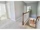 Light-filled hallway with carpet, stairs, and white railings connecting different areas of the home at 2827 Upper Park Road, Orlando, FL 32814