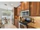 Elegant kitchen featuring wood cabinets and stainless steel appliances at 2827 Upper Park Road, Orlando, FL 32814