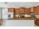 Spacious kitchen featuring granite countertops, wood cabinets, and stainless steel appliances at 2827 Upper Park Road, Orlando, FL 32814