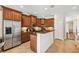 Traditional-style kitchen with granite countertops, wood cabinets, and stainless steel appliances at 2827 Upper Park Road, Orlando, FL 32814