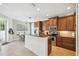 Well-lit kitchen with wood cabinets, granite countertops, and stainless steel appliances at 2827 Upper Park Road, Orlando, FL 32814