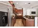 Modern kitchen featuring granite countertops, stainless steel appliances, and custom wood cabinetry at 2827 Upper Park Road, Orlando, FL 32814