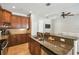 Open kitchen area with granite countertops and wood cabinets at 2827 Upper Park Road, Orlando, FL 32814