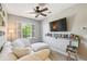 Comfortable living area features white sofa, media center, and plantation shutters on windows at 2827 Upper Park Road, Orlando, FL 32814