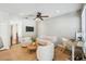 Comfortable living room features tile flooring, ceiling fan, sofa, chairs and a desk at 2827 Upper Park Road, Orlando, FL 32814