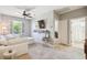 Cozy living area with light gray carpet, ceiling fan, shelving and access to the ensuite bathroom at 2827 Upper Park Road, Orlando, FL 32814