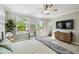 Bright primary bedroom with plantation shutters, ensuite and ceiling fan at 2827 Upper Park Road, Orlando, FL 32814