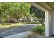 Serene street view framed by lush, mature trees, showcasing the neighborhood's peaceful ambiance at 2827 Upper Park Road, Orlando, FL 32814