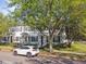 Charming townhomes shaded by mature trees with a white car parked in front, exuding curb appeal at 2827 Upper Park Road, Orlando, FL 32814